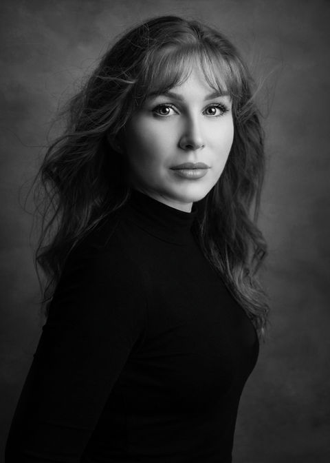 Black and white studio portrait of a woman in profile, photographed in a Portishead portrait studio with fine art lighting.