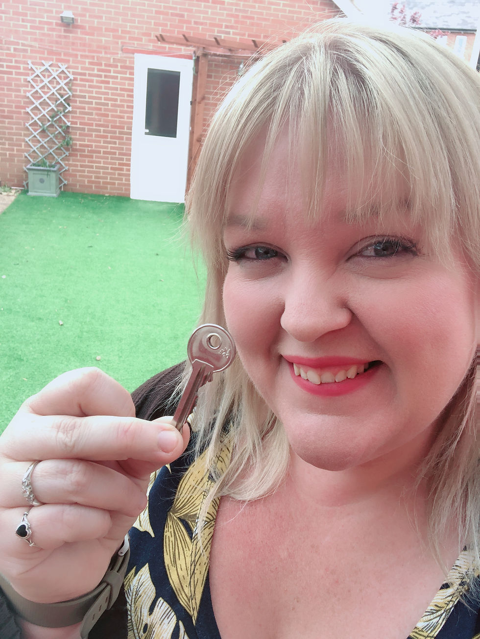 a girl holding up the key to her new photo studio in bristol
