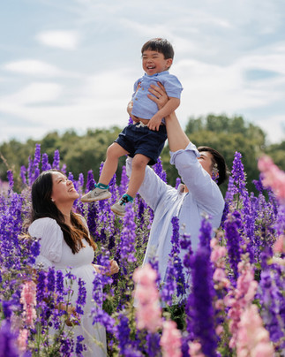 Fun outdoor family photography session in Bristol with parents lifting their child