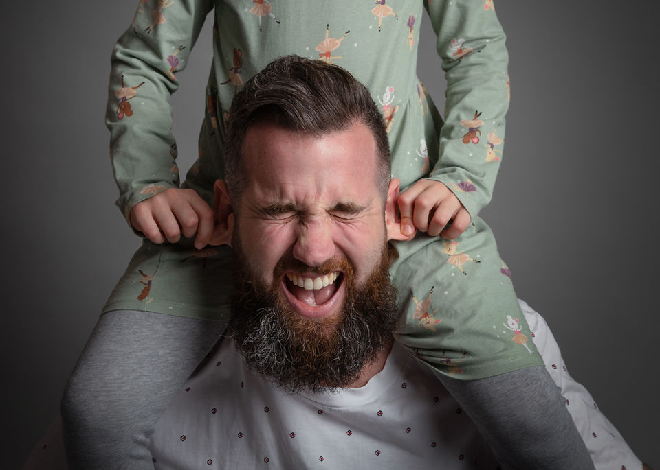 Playful family photography in Bristol capturing a parent laughing with their child
