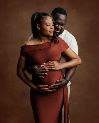 maternity couple portrait with pregnant woman in rust dress embracing partner Bristol maternity photography