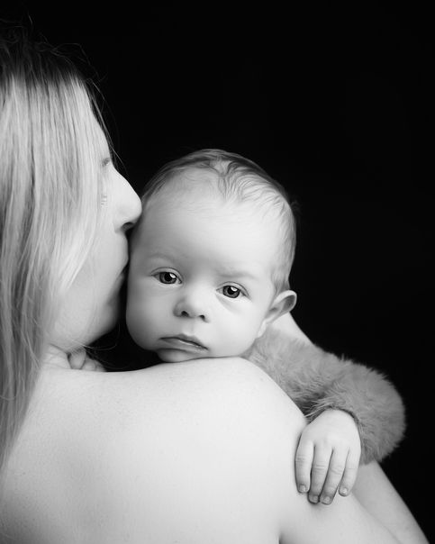 Black and white newborn photography portrait capturing a baby resting peacefully