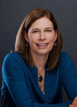 LinkedIn headshot in a Bristol studio of a woman in a blue top, relaxed and professional portrait
