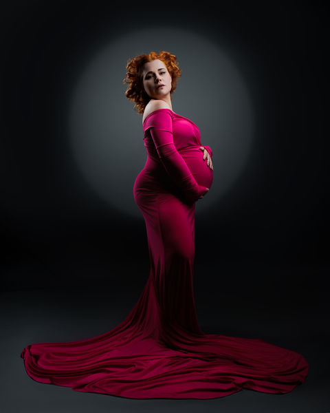 pregnant woman standing in magenta dress with long train maternity photography Bristol