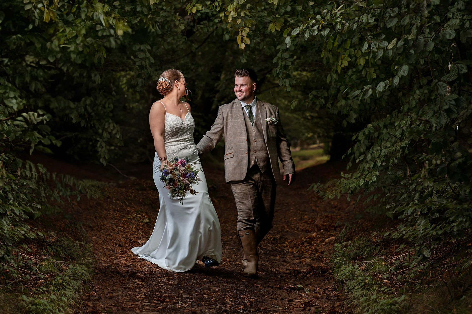 Bride and groom walking together outdoors after their wedding ceremony