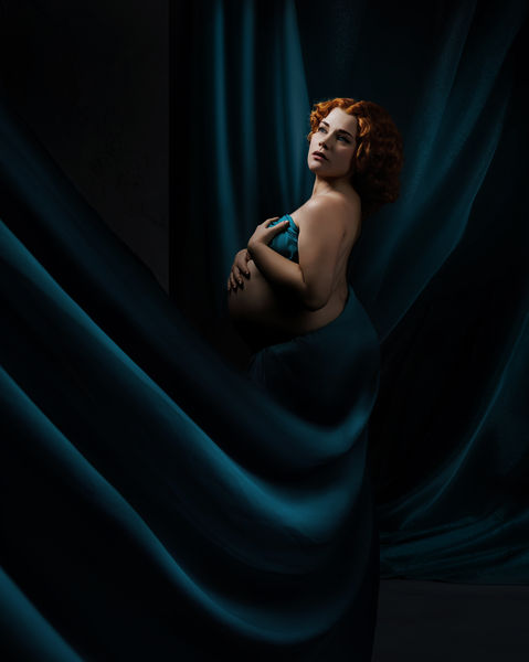 pregnant woman wrapped in flowing blue fabric artistic maternity photography Bristol studio