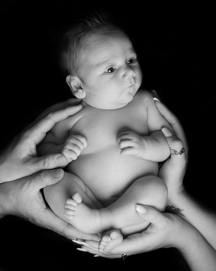 Studio newborn portrait in Portishead showing baby curled comfortably on a blanket