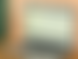 Laptop displaying a stock market graph, set on a table with warm striped shadows. Screen shows NASDAQ, numbers, and rising trend line.