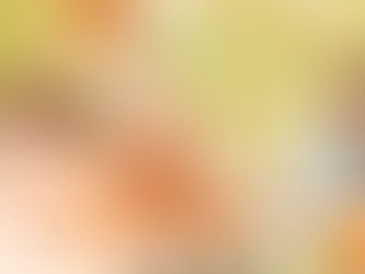 Three people smiling and dining outdoors, surrounded by greenery. A woman holds a fork, a pitcher of orange juice on the table. Warm, sunny mood.