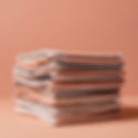 a magazine stack of a few magazines on a peach colour background.jpg