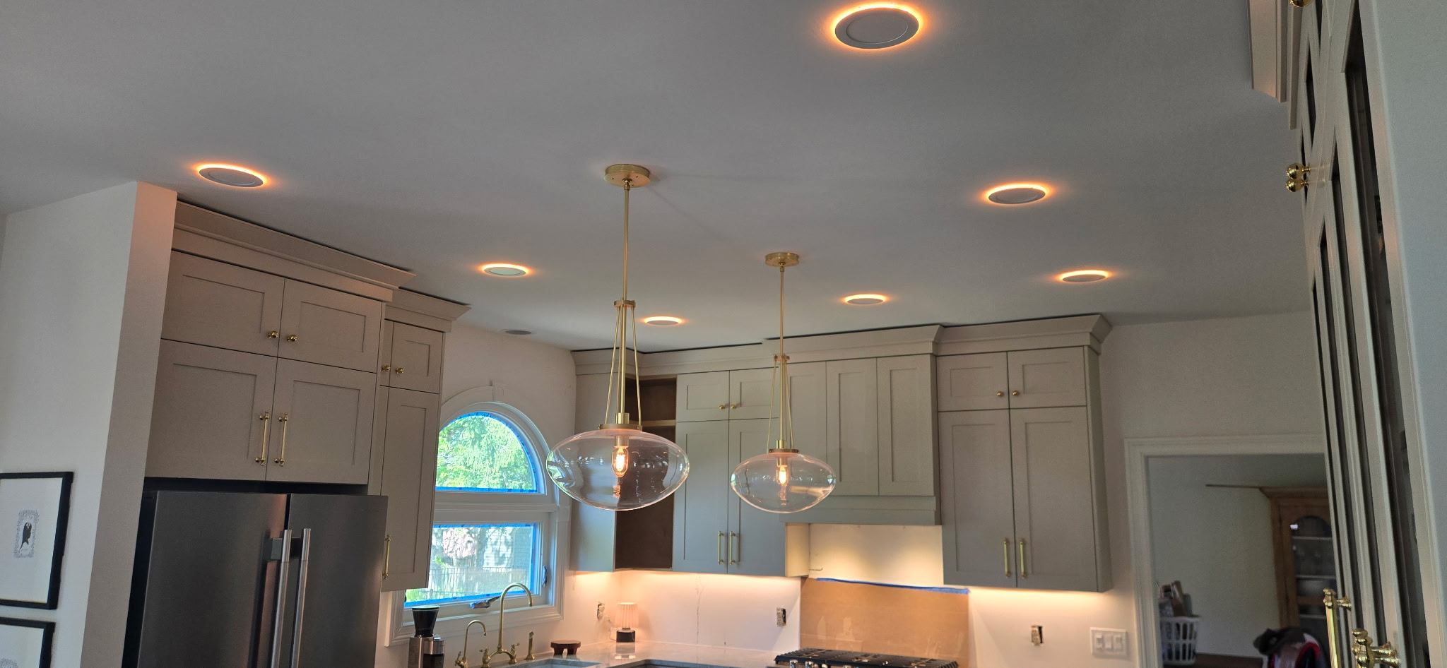 Kitchen lighting by Lytle Electric: warm recessed lights, glass pendants and under-cabinet lighting
