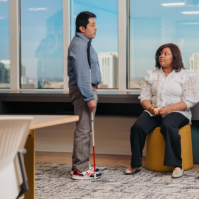 Three Colleagues Chat in an Office.jpg