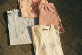 Clean T-shirts and shorts folded neatly and laid flat for a photoshoot.