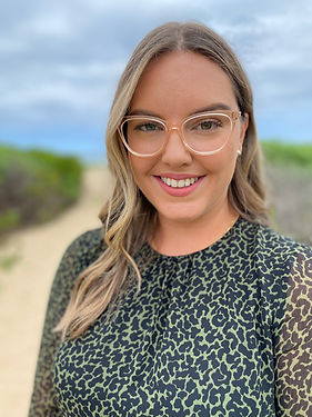 A photo of speech pathologist Rose Spiller at the beach smiling