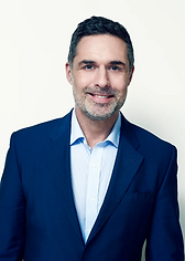A man in a suit in front of a white background