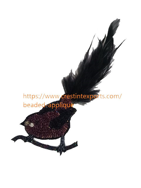 Black sparkly bird brooch with long tail feathers