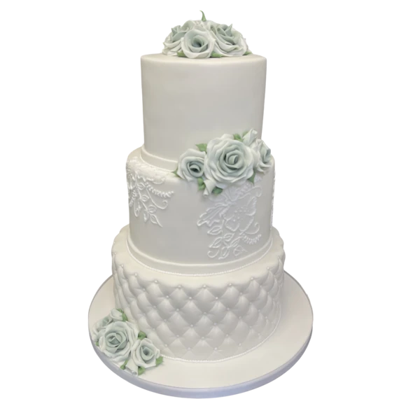 Three-tiered white wedding cake with pastel sugar paste roses and lace patterns.
