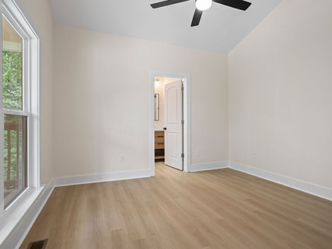 Finished bedroom with wood flooring and ceiling fan at 9 Dahlgreen