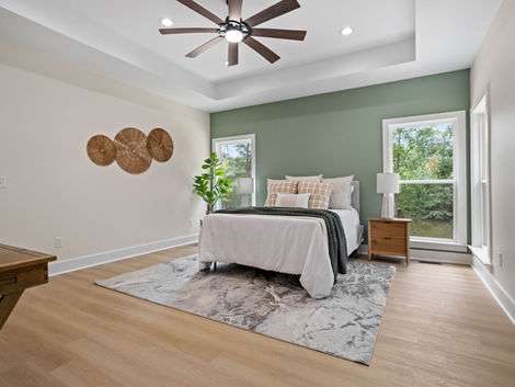 Finished bedroom with wood flooring and ceiling fan at 9 Dahlgreen