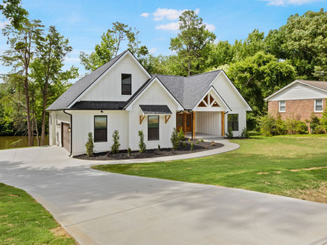 9 Dahlgreen new construction home with white siding, driveway, and landscaping