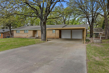 Established single-story brick home with mature trees in Azle, Texas