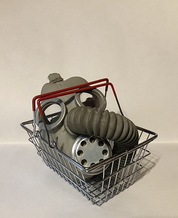 Childs gas mask in a childs' play shopping basket