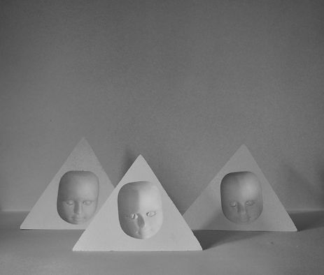 faces contained inside pyramids 13cm in height 16cm at the widest plane and and 8cm in depth.