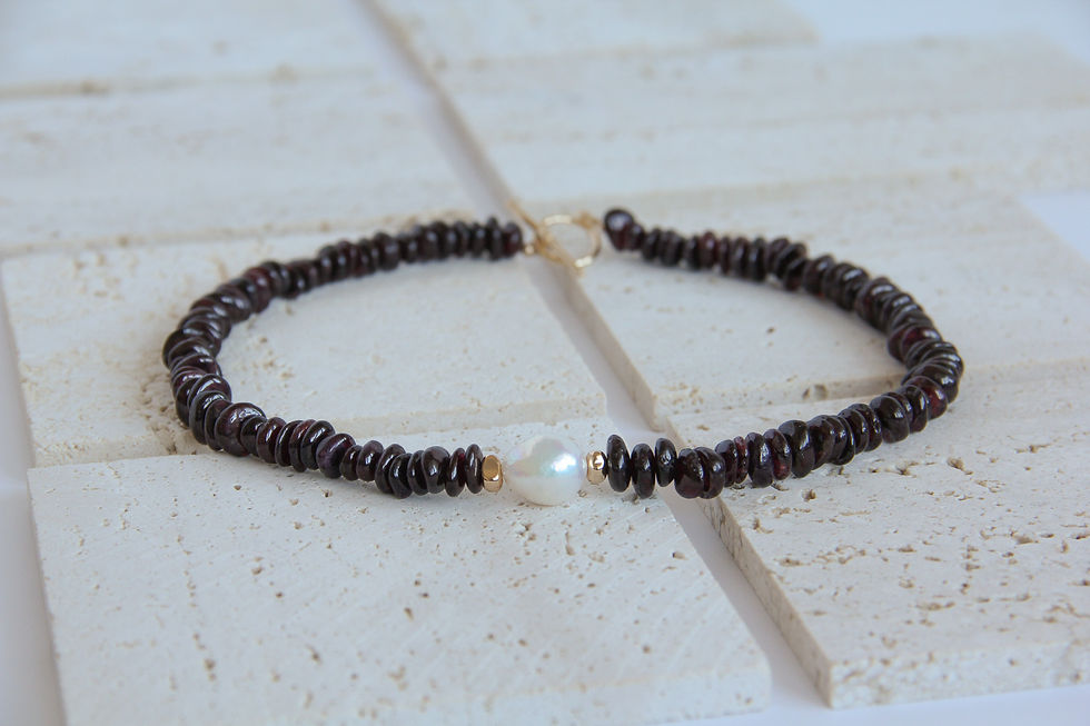 Elegant gemstone bracelet with a central pearl, exquisite Kleynot Jewellery design.