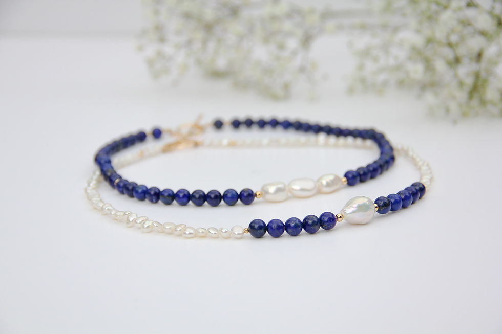 necklacec set of 2, one made with lapis lazuli beads and 3 white baroque pearls at its centre, and the other one mainly made with white pearls and lapis lazuli beads with a pearl at its centre