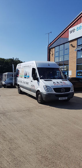 A commercial removals van parked outside a building in Stamford.