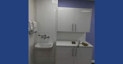 A small kitchen being built with white cabinets