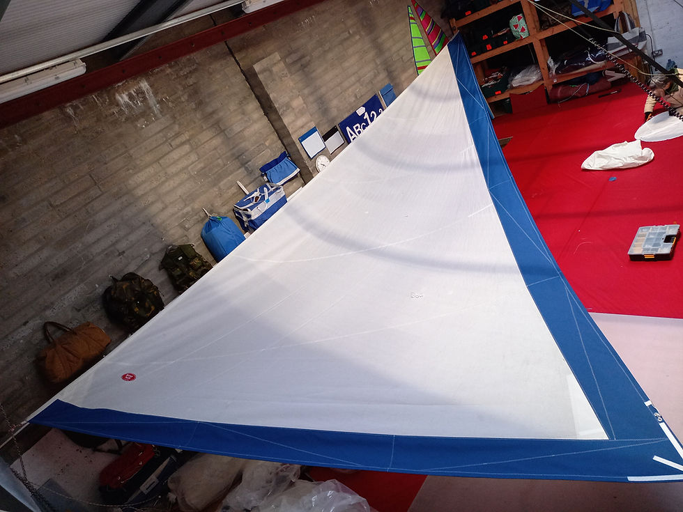 Blue and white boat sail repair