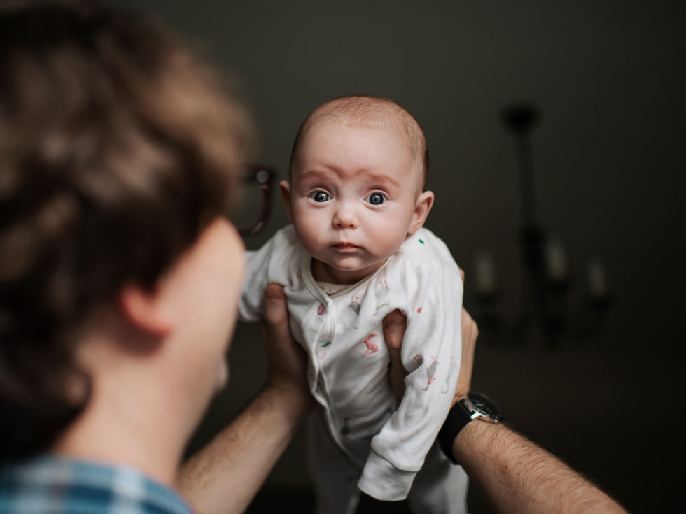 dad holding little baby up in air | newborn photography newcastle | Angela Fenwick Photography