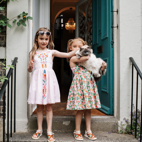 two girls in doorway one holding a cat | family photography Newcastle | Angela Fenwick Photography