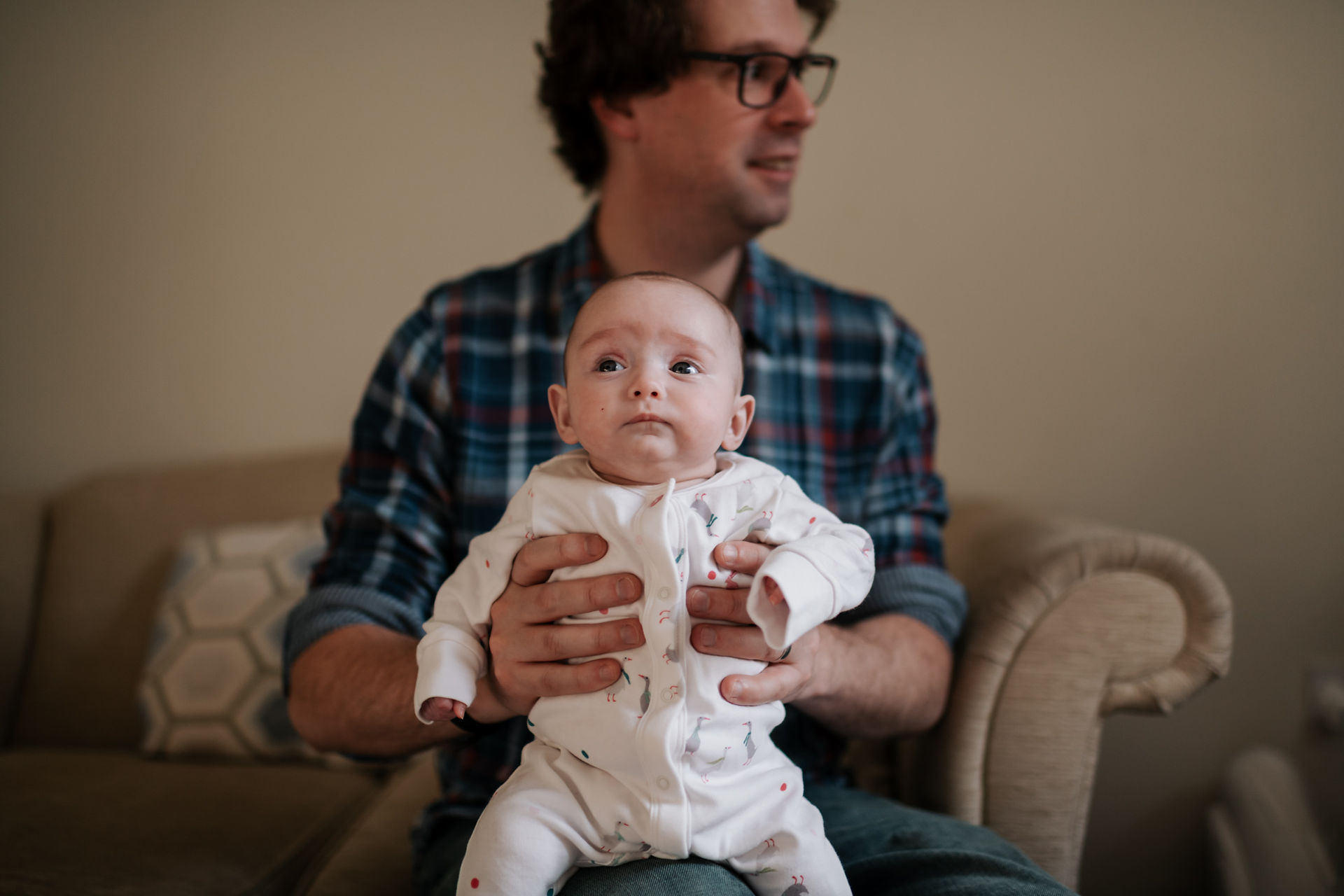 dad holding little baby on knee  | newborn photography newcastle | Angela Fenwick Photography