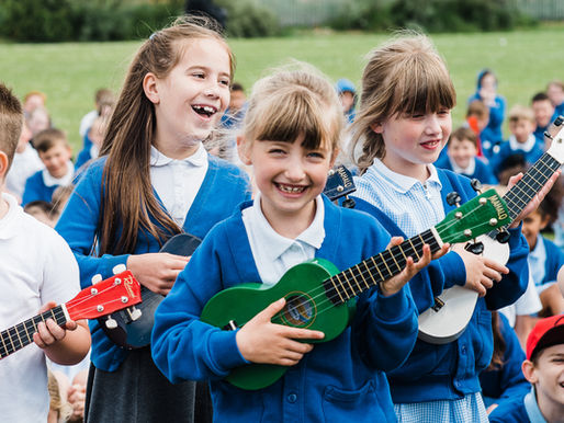 children playing coloured guitars | documentary commercial photography county durham | Angela Fenwick Photography