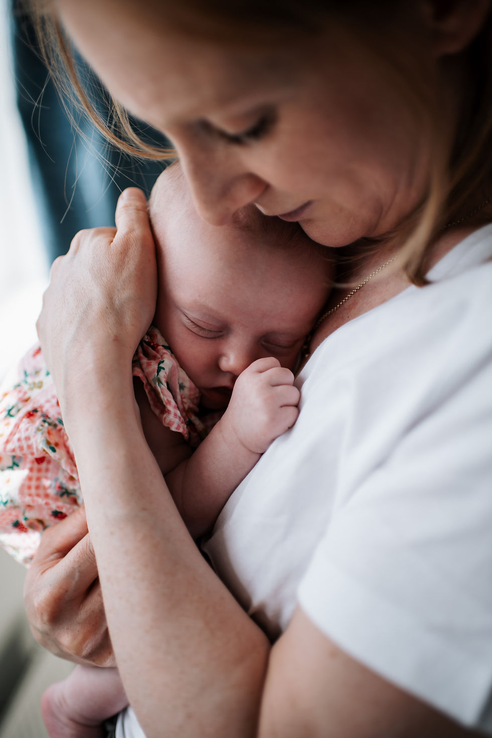Newborn photos Newcastle. Mother snuggling newborn baby.