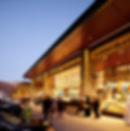 Traditional open-air market in Sharjah UAE with stone walls and warm lighting, modern sustainable architecture blending with Hajjar Mountains by Architect Shabeeb Mohammed and Shape Architecture Practice.