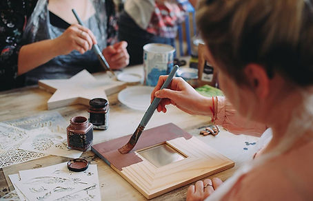 People painting wooden blocks and frames
