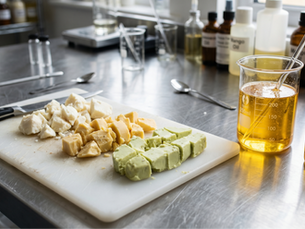 a chopping board with raw butter and oil ingredients