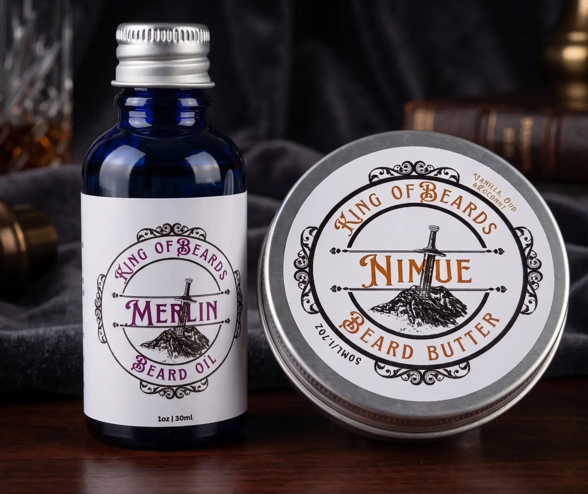 A 30ml blue glass bottle of Merlin Beard Oil next to a 50ml tin of Nimue Beard Butter on a dark wooden table with a soft dark