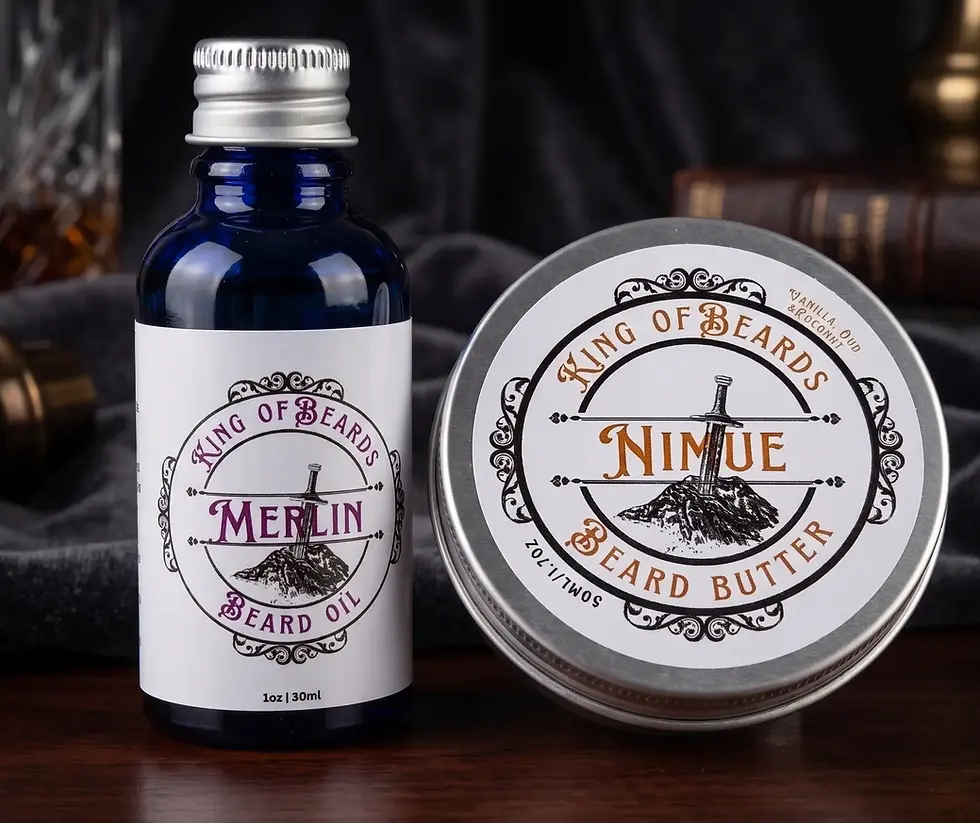 A 30ml blue glass bottle of Merlin Beard Oil next to a 50ml tin of Nimue Beard Butter on a dark wooden table with a soft dark