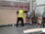 A man wearing a high viz cutting wood on a large machine