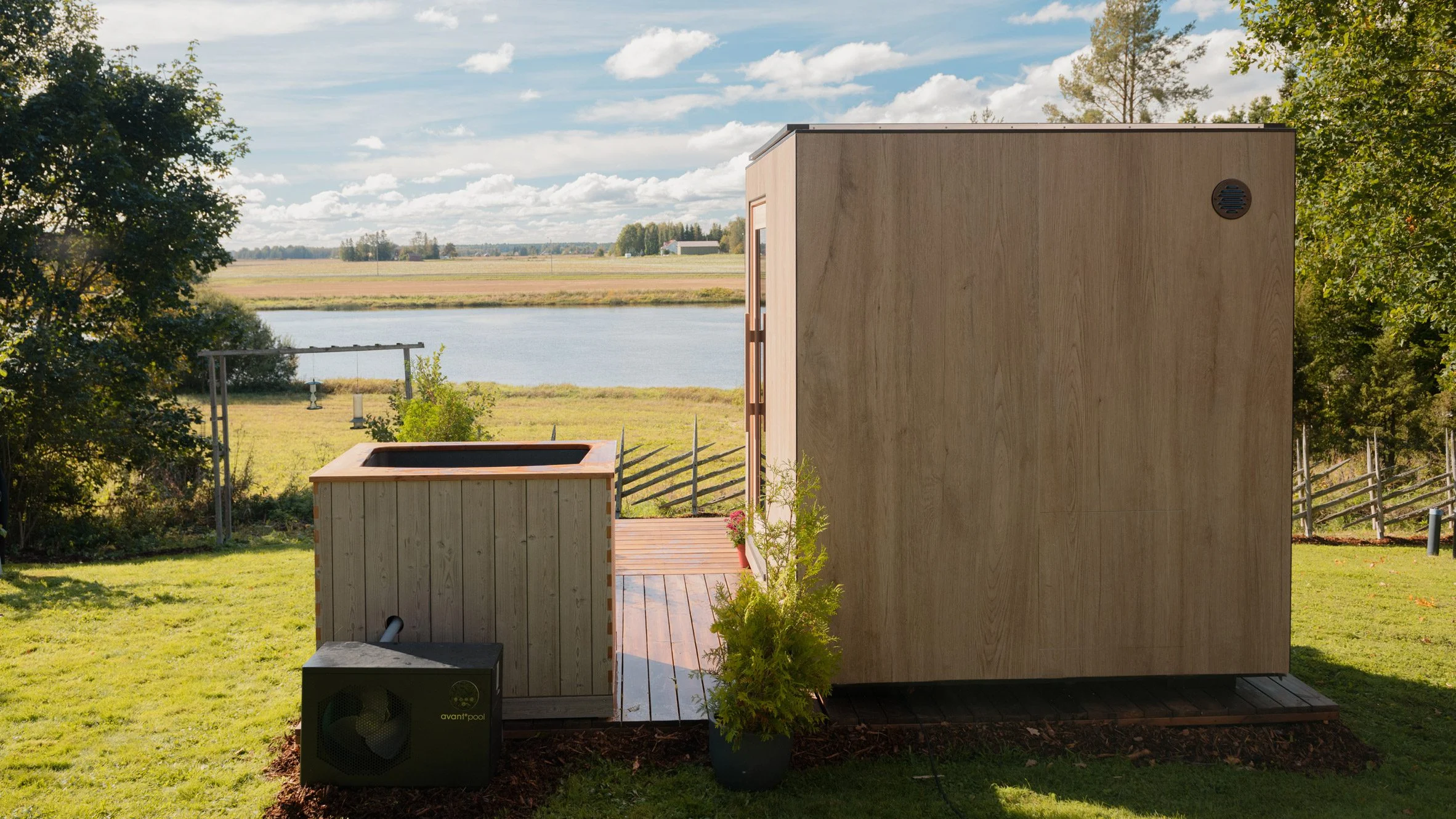 solar powered sauna in a back yard with a view of the lake