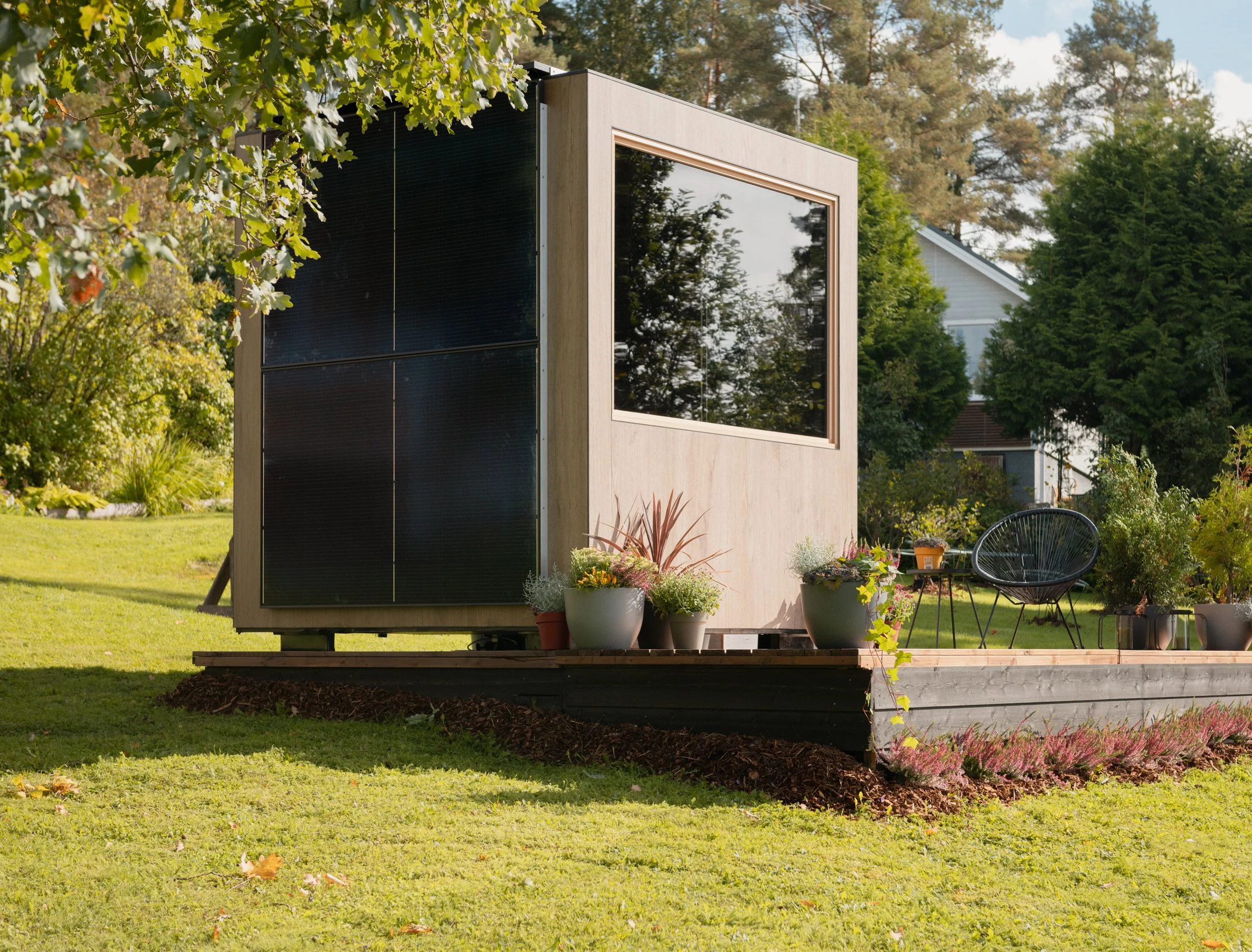 solar powered sauna in a back yard with a dark privacy glass