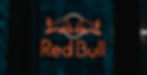 Neon Red Bull logo sign with two bulls facing each other against a dark background, creating a bold and energetic mood.