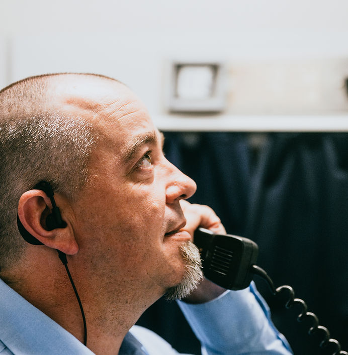 Train crew member coordinating operations on the phone
