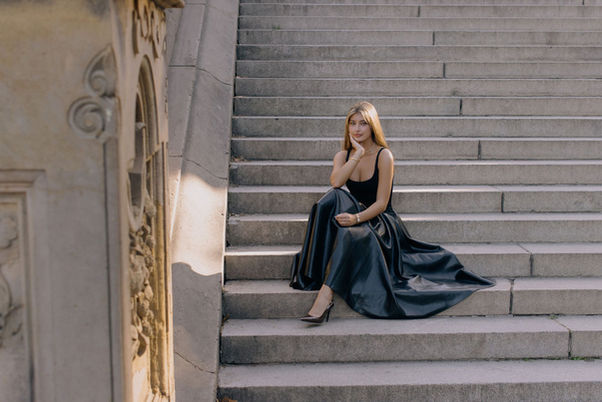 Elegant woman portrait sitting on building steps New York City
