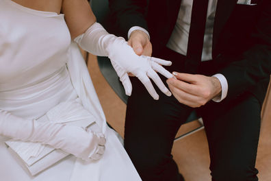 Wedding ring exchange over white glove detail New York City
