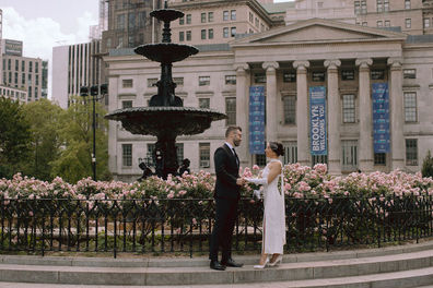 Wedding couple portrait Brooklyn Borough Hall fountain pink roses New York City